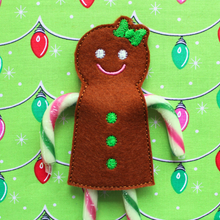 Load image into Gallery viewer, Gingerbread girl candy cane holder stitched in brown felt with green bow and buttons