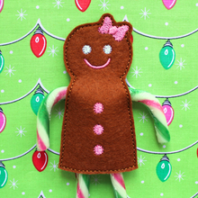 Load image into Gallery viewer, Gingerbread girl candy cane holder stitched in brown felt with pink bow and buttons