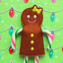 Load image into Gallery viewer, Gingerbread girl candy cane holder stitched in brown felt with yellow bow and buttons