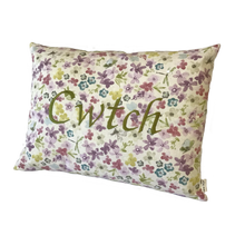 Load image into Gallery viewer, Cwtch cushion stitched in green on floral fabric viewed from the right side