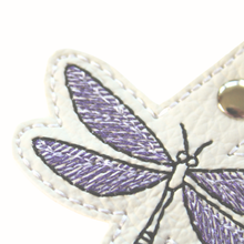 Load image into Gallery viewer, Dragonfly keyfob close up of stitched wing in purple and black thread on white faux leather