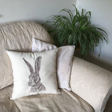 Load image into Gallery viewer, Embroidered hare cushion on a sofa