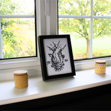 Load image into Gallery viewer, Holding Hands artwork on a windowsill