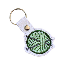 Load image into Gallery viewer, Knitting keyfob with green yarn and chrome rivet and split ring