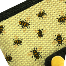Load image into Gallery viewer, Close up of notebook fabric with bumblebee fabric on black faux leather