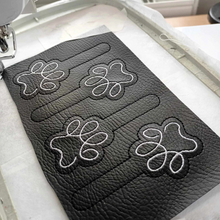Load image into Gallery viewer, Paw print keyfobs completed stitching ready for cutting out and finishing with hardware
