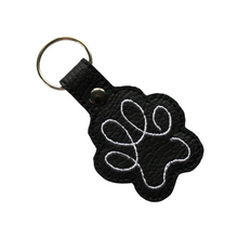 Load image into Gallery viewer, Paw print keyring in black faux leather with white stitching and metal rivet and split ring