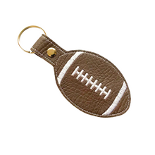 Load image into Gallery viewer, Rugby ball keyfob with white stitching on brown faux leather with metal rivet and split ring