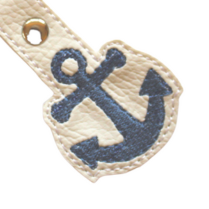 Close up of stitching of Anchor keyfob on white faux leather
