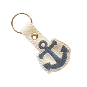 Anchor key ring on white faux leather with blue stitching
