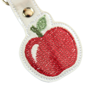 Apple keyfob close up of stitching with white border