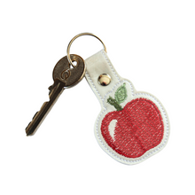 Load image into Gallery viewer, Apple keyfob with key and white border

