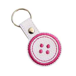 Button keyfob with pink thread and chrome rivet and split ring