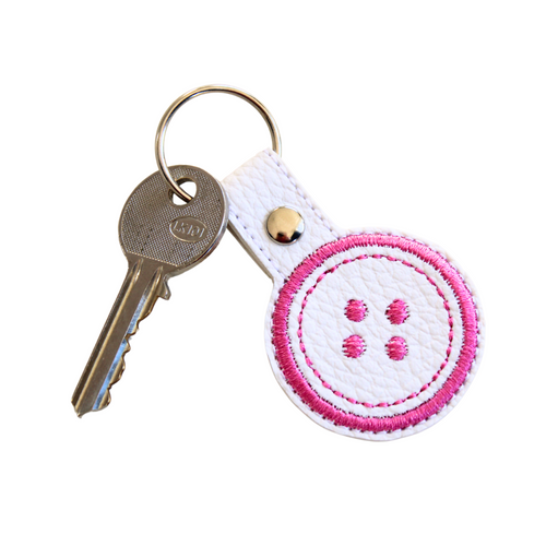 Button keyfob with pink thread and attached key