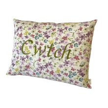 Load image into Gallery viewer, Cwtch cushion stitched in green on floral fabric viewed from the right side
