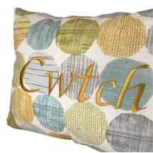 Load image into Gallery viewer, Cwtch cushion on light blue and yellow circles close up of stitching
