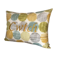 Load image into Gallery viewer, Cwtch cushion on light blue and yellow circles viewed from the right side
