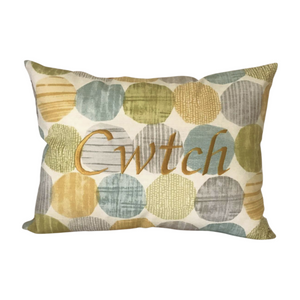 Cwtch cushion on light blue and yellow circles