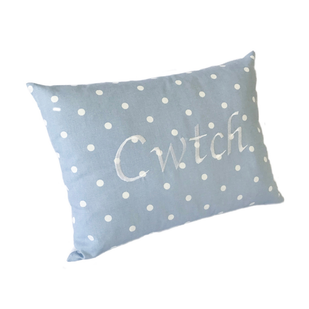 Cwtch cushion in powder blue polka dot with white stitching
