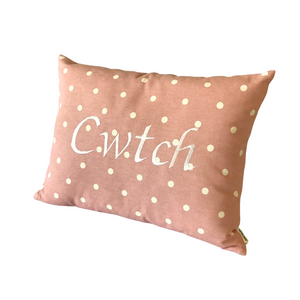 Cwtch cushion with white words on pink and white polka dot fabric