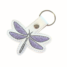Load image into Gallery viewer, Dragonfly keyfob stitched on white faux leather with purple and black thread and finished with a chrome rivet and split ring
