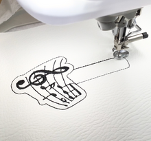 Load image into Gallery viewer, Musical notes keyfob being stitched

