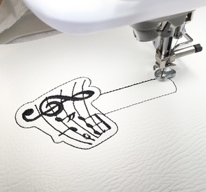 Musical notes keyfob being stitched