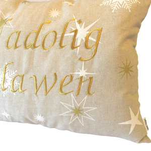 Nadolig Llawen cushion in gold close up of stitching