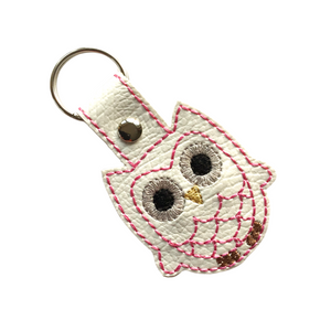 Owl keyfob with pink outline stitching on white faux leather finished with a metal rivet and split ring