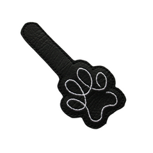 Load image into Gallery viewer, Paw print keyfob in black faux leather cut out ready for finishing with metal hardware
