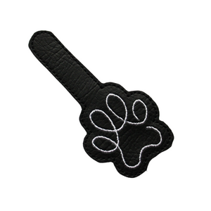 Paw print keyfob in black faux leather cut out ready for finishing with metal hardware