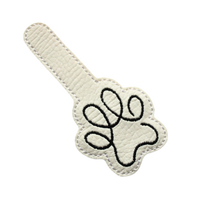 Paw print keyfob in white faux leather cut out ready for finishing with metal hardware