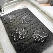 Load image into Gallery viewer, Paw print keyfobs completed stitching ready for cutting out and finishing with hardware
