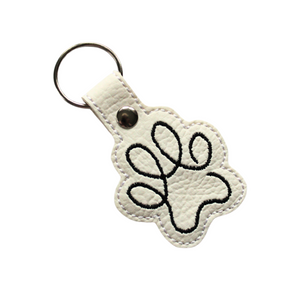 Paw print keyring in white faux leather with black stitching with metal rivet and split ring