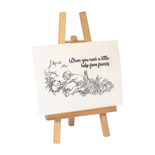 Pooh and friends embroidered art on an easel viewed from the left side