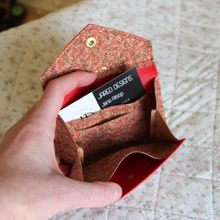 Load image into Gallery viewer, A red vine cork purse opened to show the credit card inserts, receipt pocket and central area for coins
