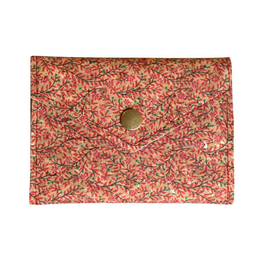A vine patterned cork purse with red and brown coloured vines and finished with a bronze coloured metal fastener.
