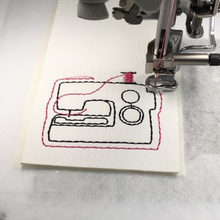 Load image into Gallery viewer, Sewing machine keyfob being stitched with pink thread
