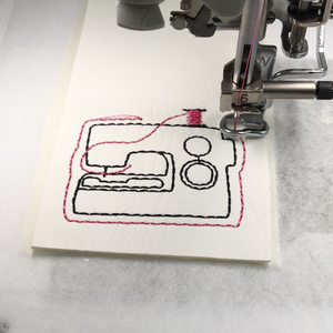 Sewing machine keyfob being stitched with pink thread
