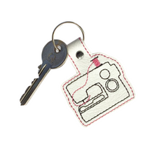 Load image into Gallery viewer, Sewing machine keyfob with pink thread and key attached

