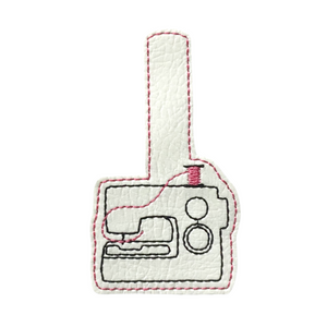 Sewing machine keyfob with pink thread cut out ready for finishing
