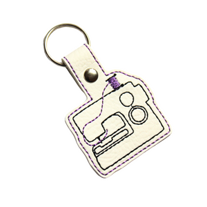 Sewing machine keyfob with purple thread