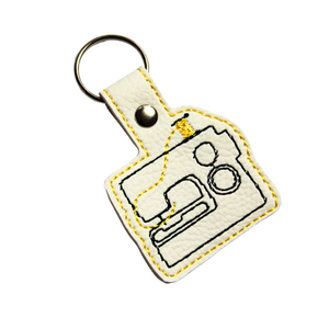 Sewing machine keyfob with yellow thread