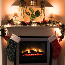 Load image into Gallery viewer, Snowflake Christmas stockings hanging over a fireplace
