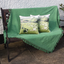 Load image into Gallery viewer, Welsh hillsides cushion on a bench
