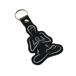 Yoga keyfob in black faux leather with white stitching