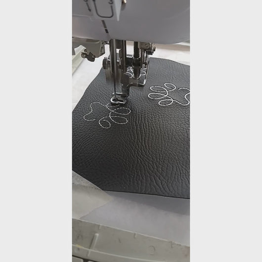 Pawprint keyfob being stitched on an embroidery machine