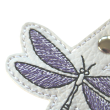 Load image into Gallery viewer, Dragonfly keyfob close up of upper wing stitched in purple and black thread on to white faux leather
