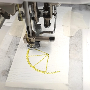 Lemon slice keyfob being stitched