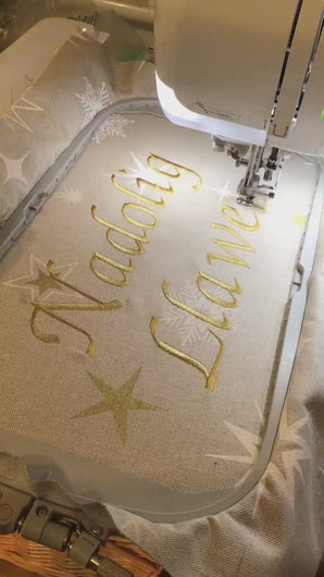 Nadolig Llawen cushion in gold being stitched video
